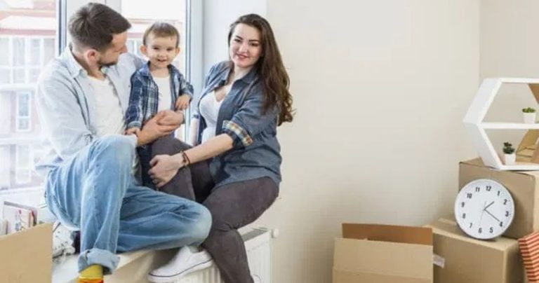 Happy family with boxes moving house
