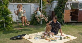 TRIBIT StormBox Mini Plus Speaker, in garden on picnic blanket with family