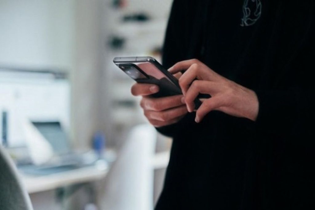 A person looking at an unknown number calling their mobile phone